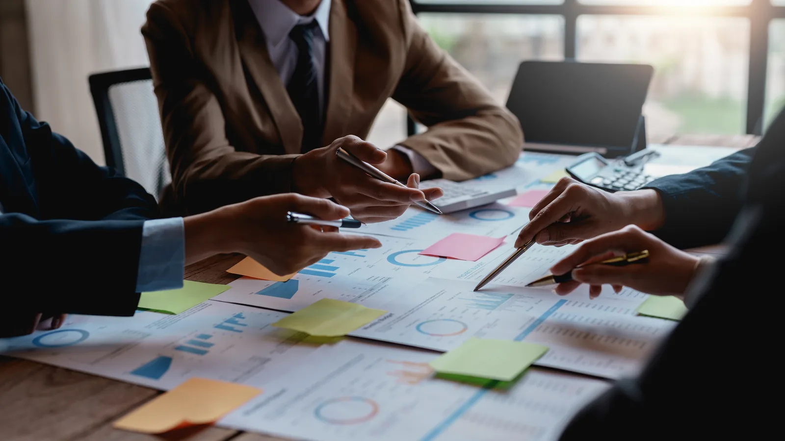 Business team reviewing strategy documents around a meeting table